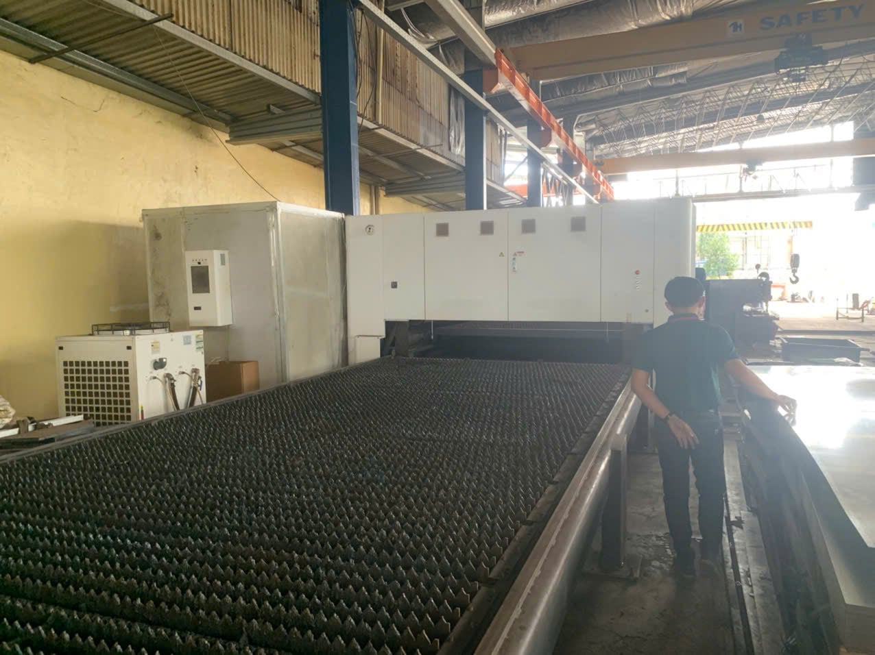 Laser cutting machine running sheet stock at An Thanh Technology, a DEWIN-verified Vietnamese supplier facility